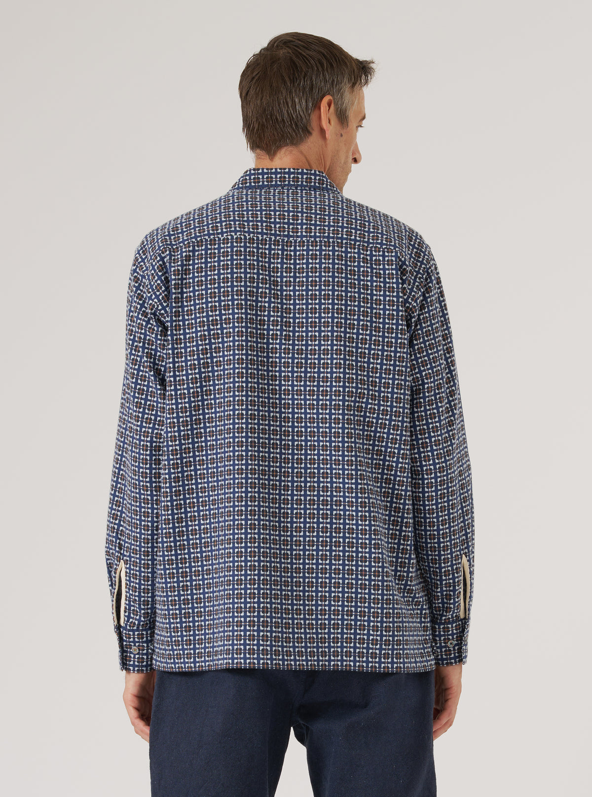 Back view of a man wearing the Navy Oscar Cotton L/S Camp Shirt. The shirt has a navy, brown, and white geometric pattern. Shot against a white background.