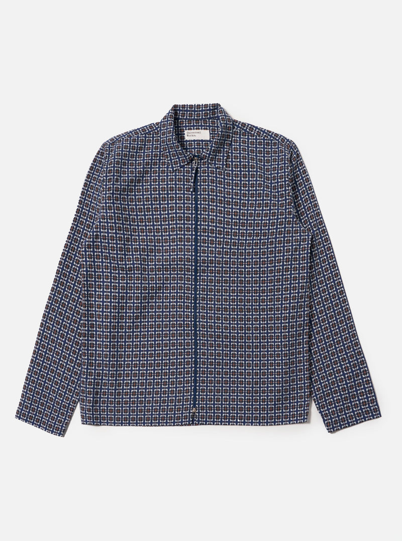 Flat lay of the Navy Oscar Cotton Zip Shirt on a white background. The shirt has a geometric pattern in navy, brown, and white. It's fully zipped and made of cotton.