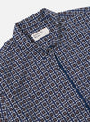 Close-up of the Navy Oscar Cotton Zip Shirt on a white background. The shirt has a navy, white, and orange pattern and a zip closure.