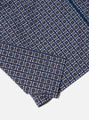Close-up of the Navy Oscar Cotton Zip Shirt, showcasing its navy, white, and orange geometric pattern on a white background. The cotton fabric and zip detail are visible.