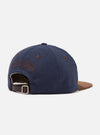 Back view of a Navy/Brown Canvas Baseball Hat on a white background. The hat is navy canvas with a brown canvas brim and a brown leather strap with a silver buckle.