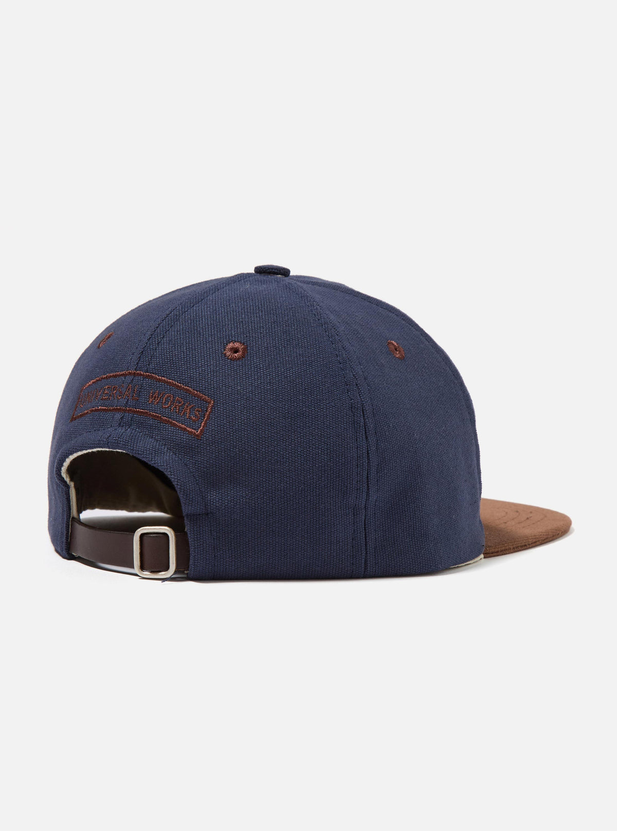 Back view of a Navy/Brown Canvas Baseball Hat on a white background. The hat is navy canvas with a brown canvas brim and a brown leather strap with a silver buckle.