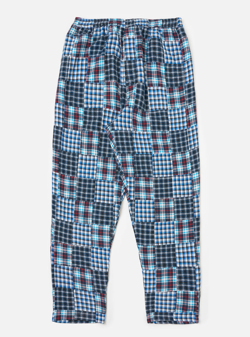 The Blue Brushed Patchwork Pyjama Pant on a white background. These cotton pants feature a blue, white, and red patchwork design and a relaxed fit.