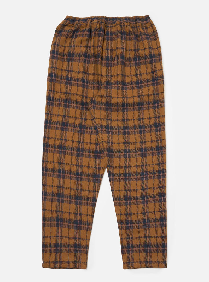 Flat lay of Caramel Twill Check Pyjama Pant on a white background. The pyjama pants are caramel with a navy and pink check pattern and have an elasticated waist.