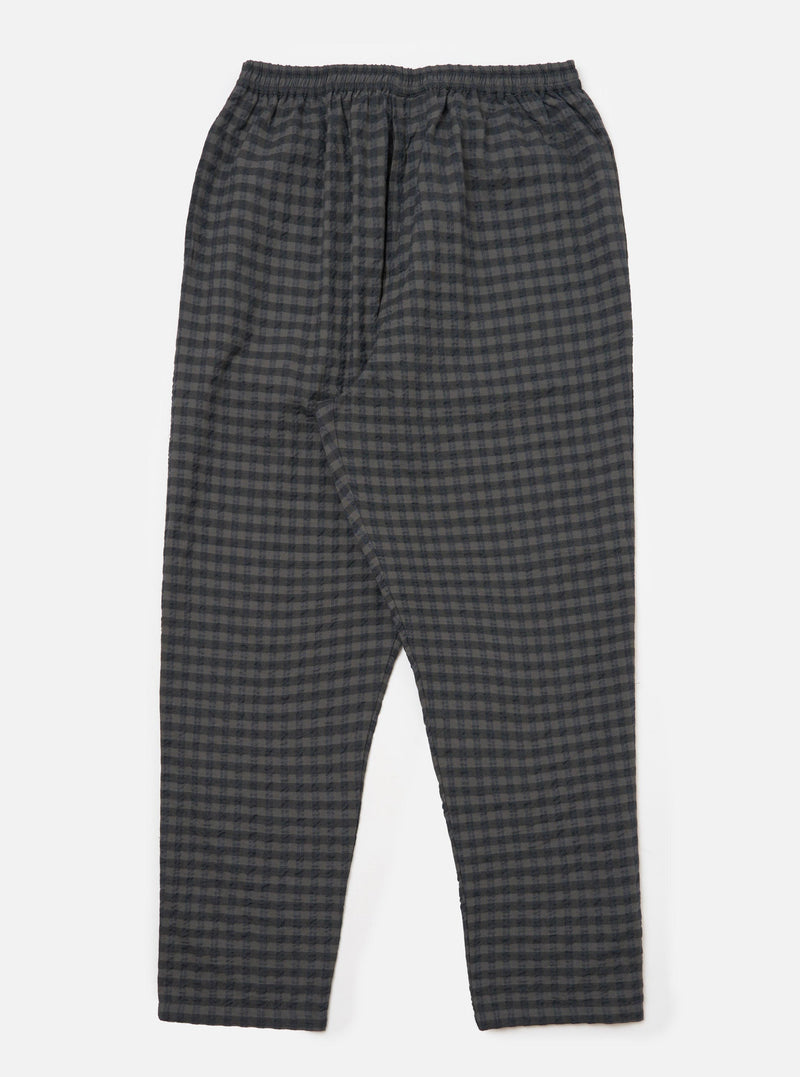 The Charcoal/Navy Seersucker Plaid Pyjama Pant on a white background. The pants have an elastic waist and a relaxed fit. The material is a textured plaid in charcoal and navy.