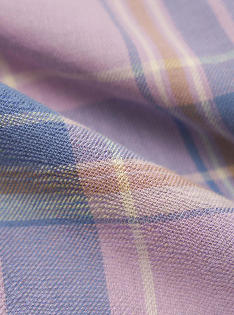 Close-up of the Pink/Blue Pastel Plaid Pyjama Pant fabric. Soft pastel pink, blue, and beige plaid pattern. The fabric is folded, showing the texture.