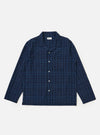 Flat lay of the Indigo Plaid Long Pyjama Set top on a white background. The top is blue plaid with long sleeves and white buttons.