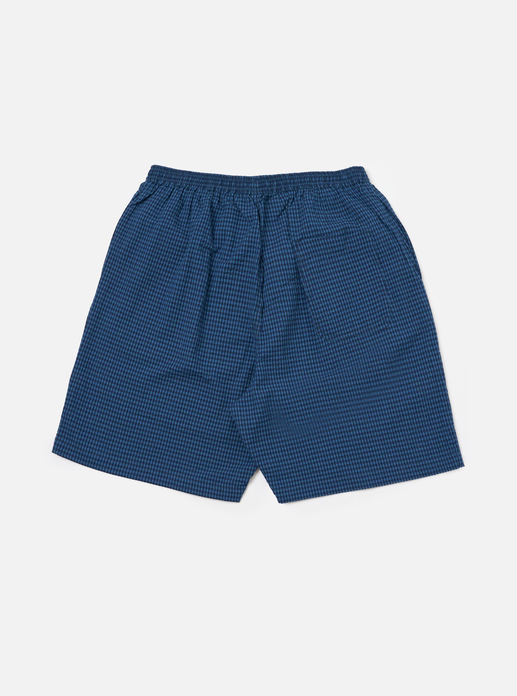 The Blue Gingham Seersucker Pyjama Short, in blue check, on a white background. The shorts have an elasticated waist.