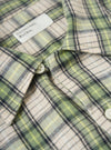 Close-up of the Green Busy Plaid Short Pyjama Set shirt, showcasing the green, beige, and black plaid pattern, button details, and brand label.