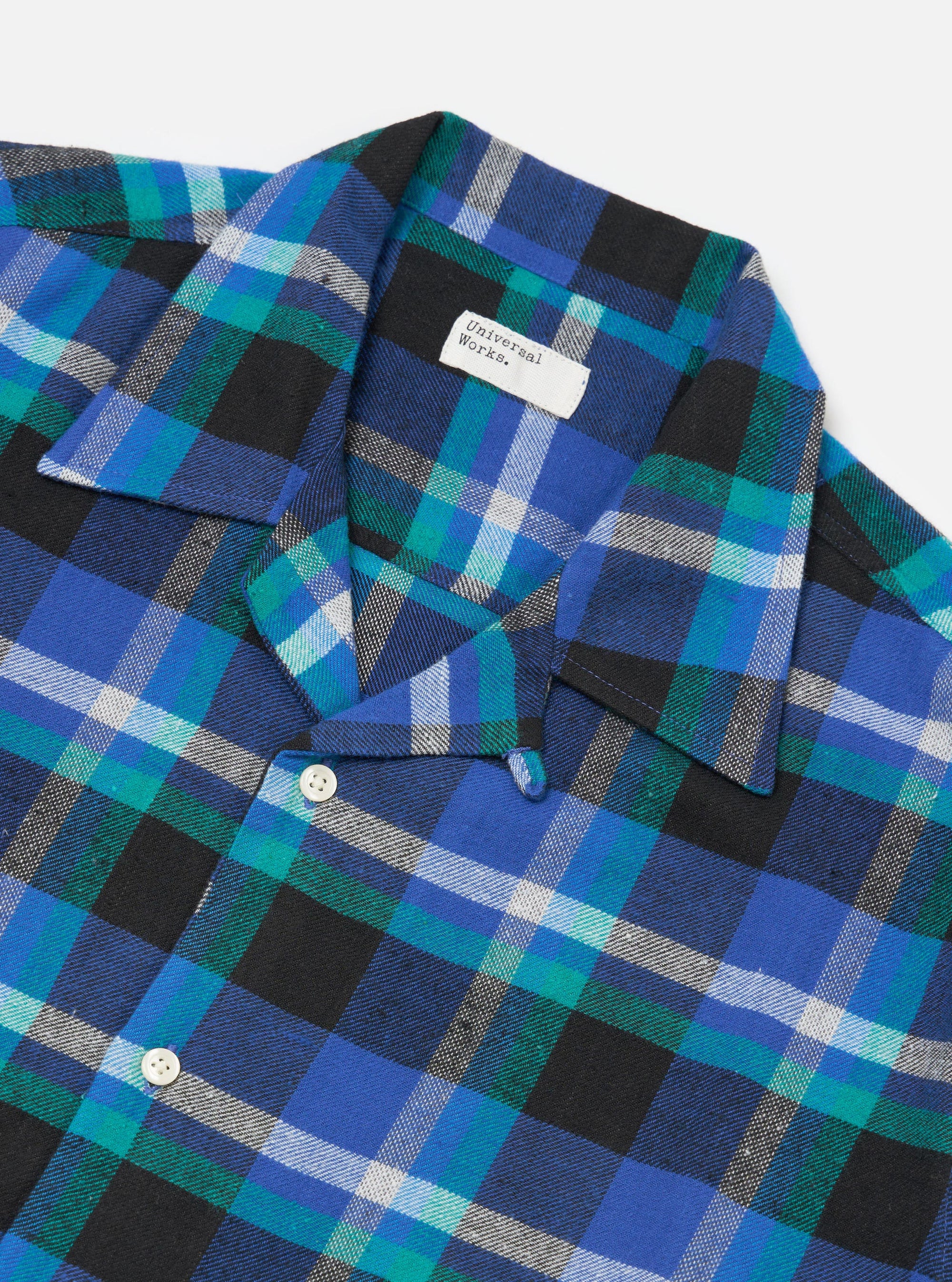 Close-up of the Blue Night Check Short Pyjama Set. The set features a blue, green, and black plaid pattern. The fabric is soft and comfortable, perfect for a good night's sleep.