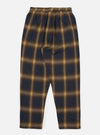 The Navy Canyon Check Pyjama Pant, laid flat on a white surface. The pants are a navy and tan plaid, with an elastic waistband.