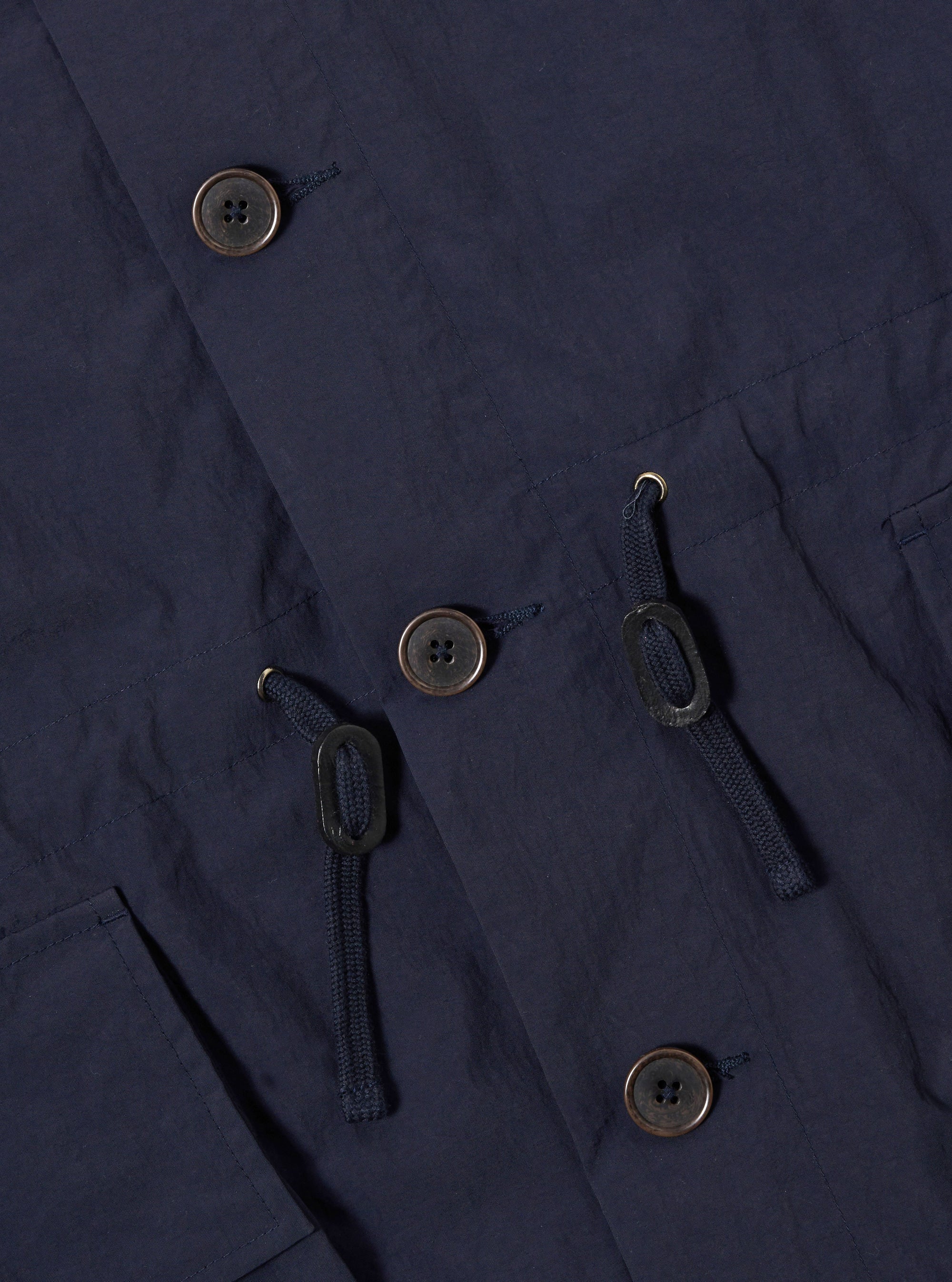 The Navy Seo Recycled Nylon Boston Parka is displayed from the back as a flat lay against a plain white background. The image highlights the garment's oversized silhouette, the large adjustable hood, and a prominent inverted box pleat at the center back. The dark navy recycled nylon fabric appears lightweight with a crisp, technical finish and visible seam details.
