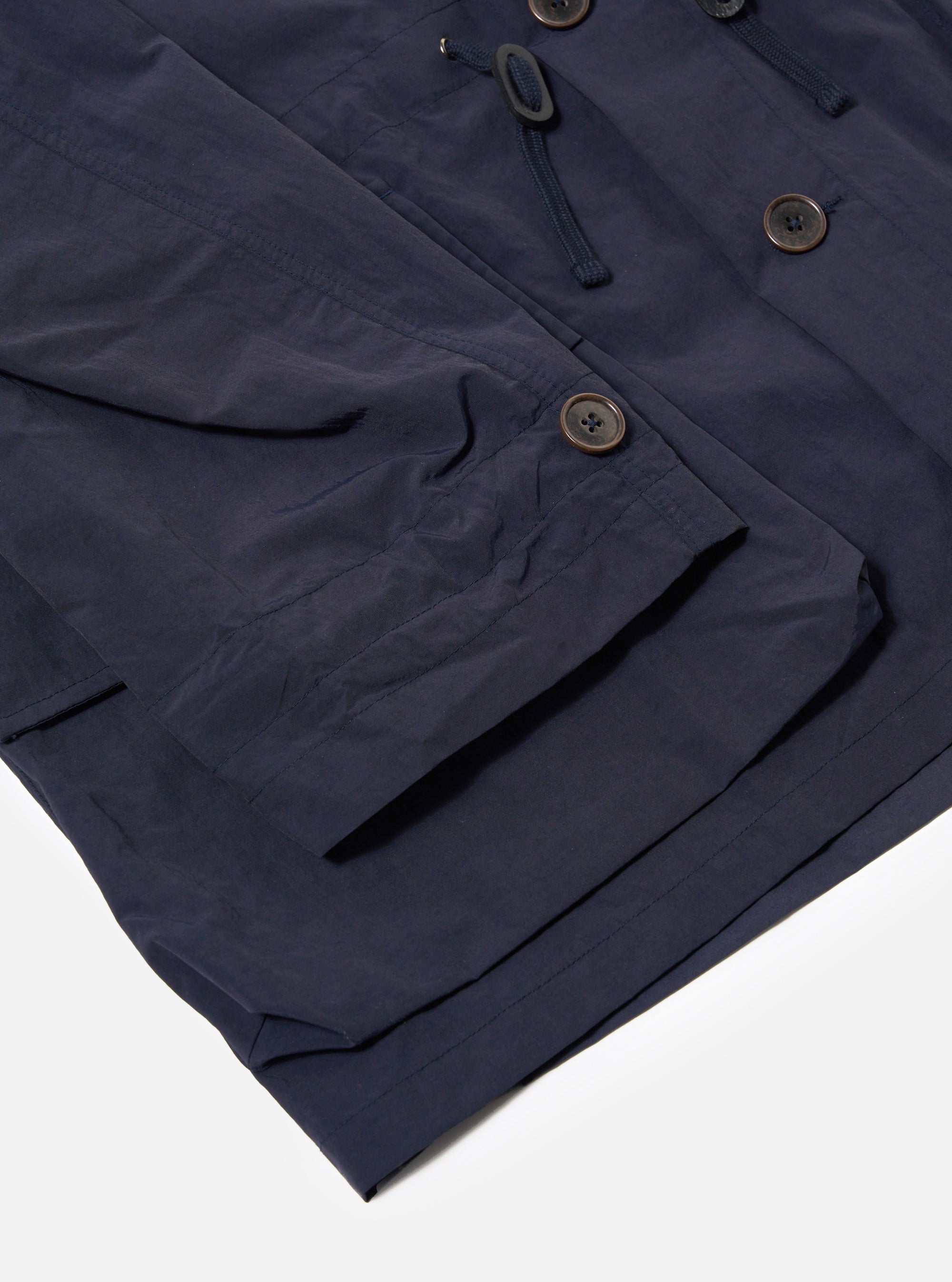 The Navy Seo Recycled Nylon Boston Parka is shown from the back as a flat lay against a plain white background. The image highlights the large, adjustable hood, the long-line silhouette, and the smooth finish of the navy recycled nylon fabric. The parka features a clean back panel with a subtle central seam and a straight hem.