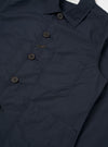 The Navy Recycled Polytech Bakers Jacket is shown as a flat lay against a white background. This chore-style jacket features a five-button front closure, a classic pointed collar, and a curved front hem. It has one patch pocket on the chest and two larger patch pockets at the hips. The fabric is a smooth, dark navy navy blend of recycled polyester and cotton.