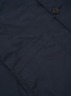 The Navy Recycled Polytech Bakers Jacket is displayed from the back as a flat lay against a white background. The image highlights the clean construction of the shoulders, the two-piece sleeve design, and the straight hem.