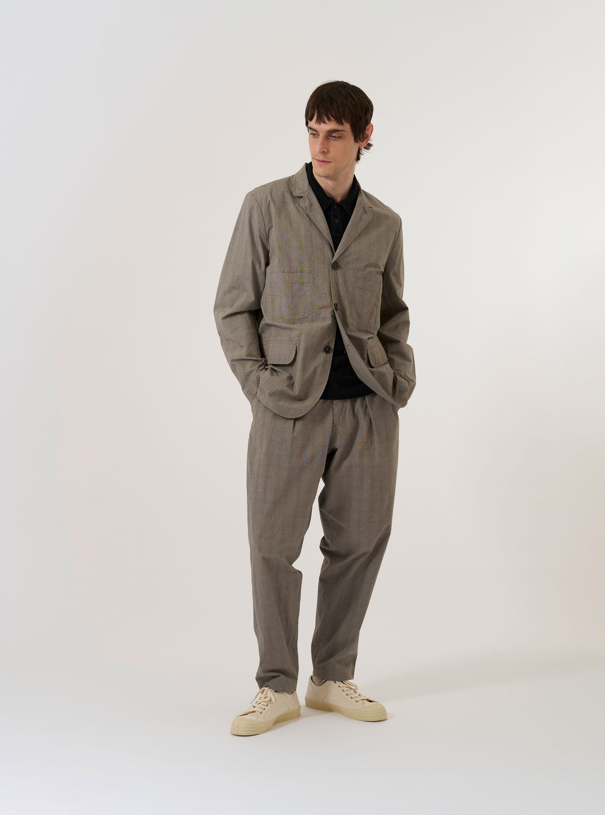 The Grey Brown Wales Glen Check Barra Jacket is shown as a flat lay against a white background. The jacket features a brown and grey Glen check pattern, a three-button front closure, a notched lapel, and two large patch pockets at the waist.