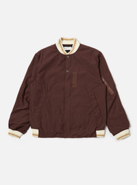 The Brown Peached Poplin NS Bomber Jacket is shown as a flat lay against a plain white background. The jacket features a central zip-front closure, two slanted welt pockets at the waist, and tonal ribbed detailing at the collar, cuffs, and hem. The cotton peached poplin fabric has a smooth, matte finish in a solid brown color.
