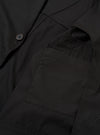 The Black Recycled Polytech Capitol Jacket is shown in a detail view as a flat lay against a plain white background. The image highlights the smooth, technical texture of the black recycled polytech fabric and the construction of the front patch pocket with a flap.
