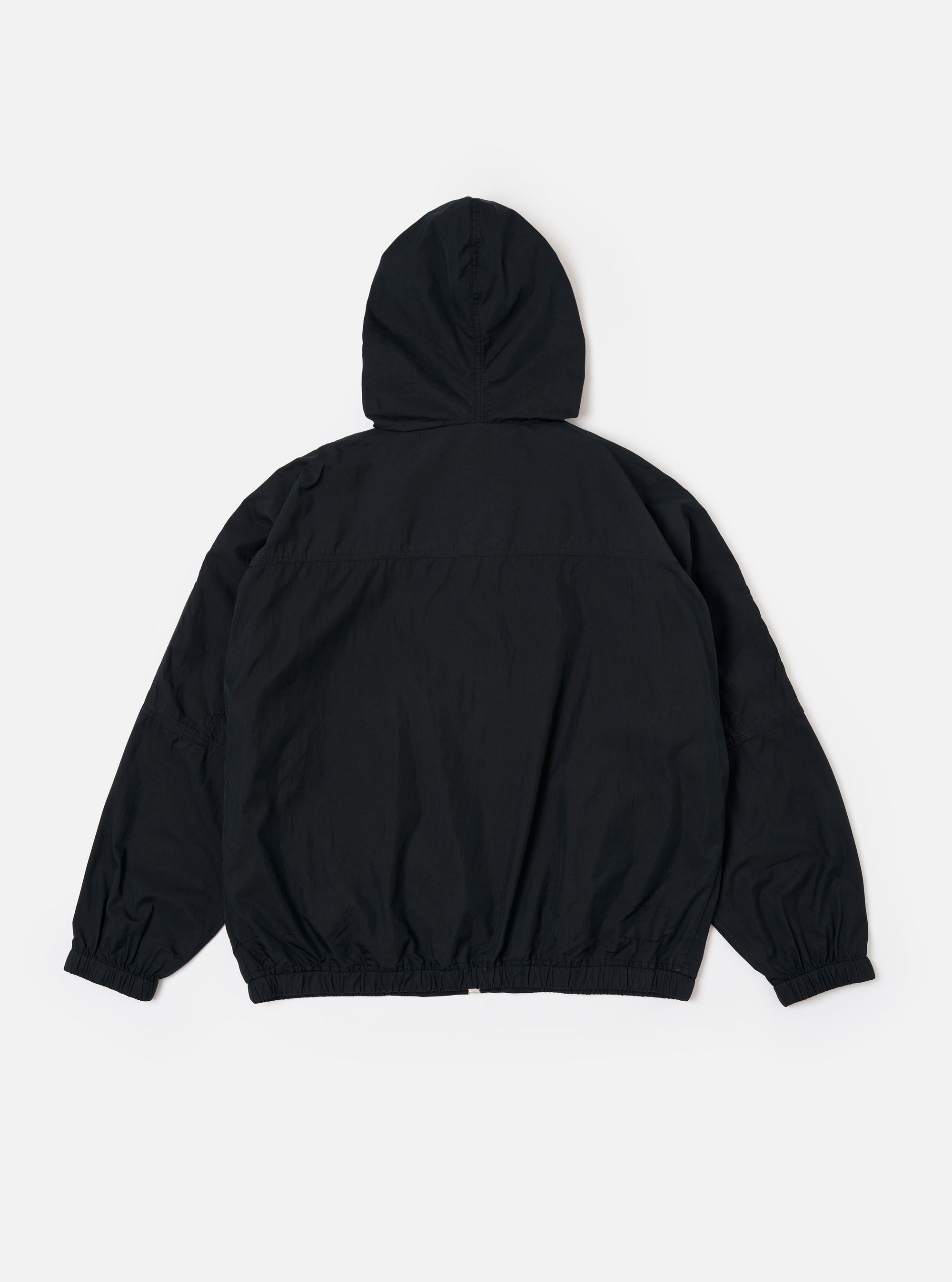 The Navy Cotton Reycled Nylon Mix Daley Jacket is shown from the back as a flat lay against a plain white background. The jacket features an oversized blouson fit with prominent panelling detail across the upper back and large, wide sleeves. The waist-length hem and cuffs are finished with a clean edge.