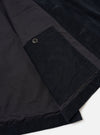 The Black Organic Fine Cord Duty Jacket is shown from the back as a flat lay against a plain white background. The image highlights the jacket's curved hem, back yoke detail, and the fine texture of the black corduroy fabric.