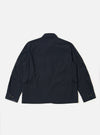 The Dark Navy Ospina Cotton Duty Jacket is shown from the back as a flat lay against a plain white background. The image highlights the jacket's curved hem, loose sleeves, and the puckered seersucker texture of the dark navy fabric.