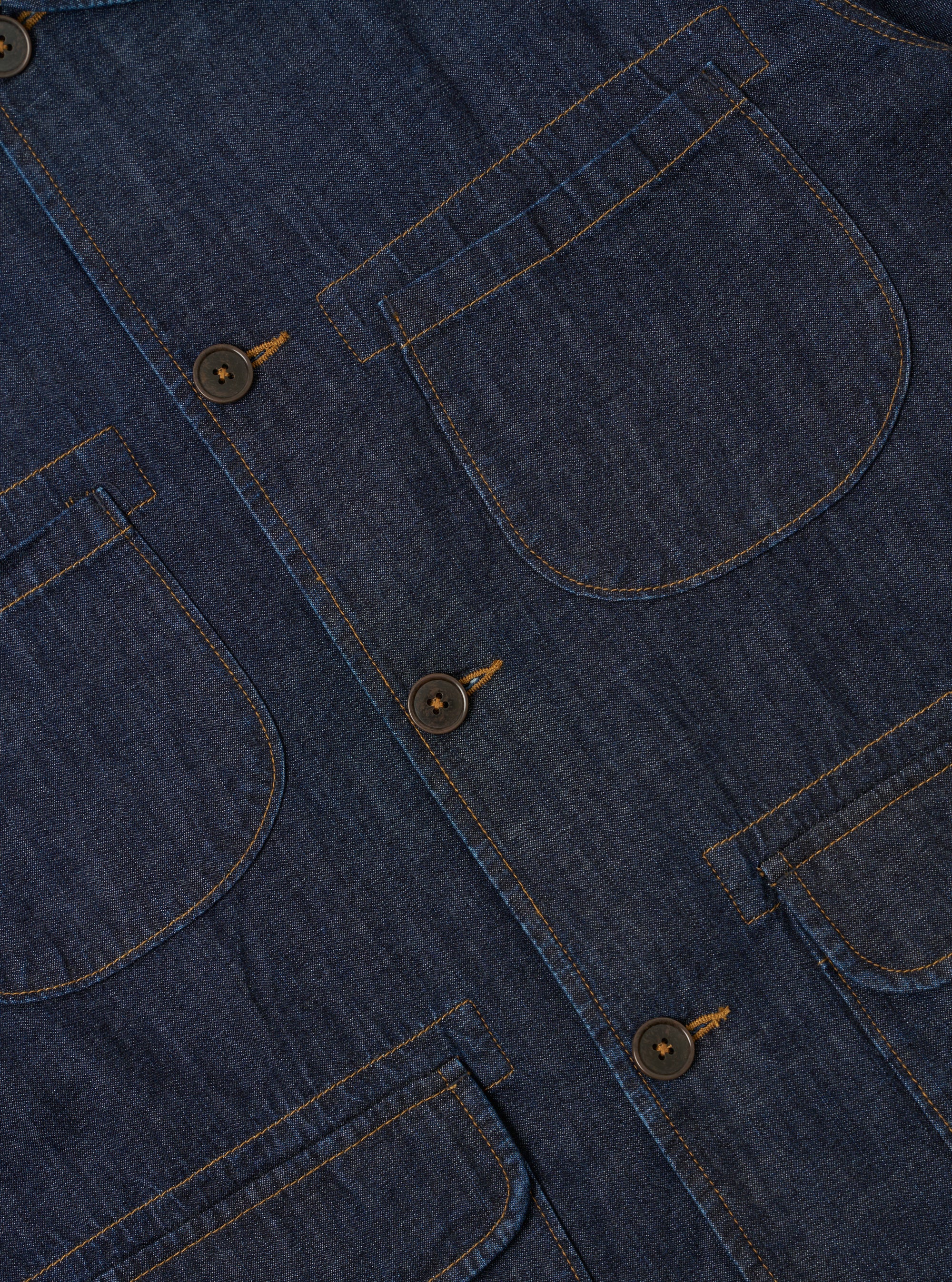 The Indigo Kaihara LT WT Denim Labour Jacket is shown from the back as a flat lay against a plain white background. The image highlights the clean construction of the garment's rear panel, featuring a straight hem and a simple one-piece back. The indigo-dyed denim fabric has a smooth, lightweight appearance with visible stitching details.