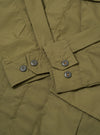 The Olive Recycled Polytech Jungle Jacket is shown from the back as a flat lay against a plain white background. The image highlights the horizontal back yoke and the clean, unstructured silhouette of the jacket.