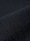 A close-up swatch image of the Dark Navy Ospina Cotton Labour Jacket fabric highlights the deep navy blue color and the distinct puckered texture of the seersucker material. The fabric fills the frame, providing a detailed view of the garment's weave and construction.
