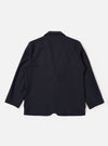 The Navy Tropical Suiting Two Button Jacket is shown from the back as a flat lay against a plain white background. The image highlights the clean, simple construction of the jacket's rear, the two-piece sleeve design, and the smooth texture of the navy tropical suiting fabric.