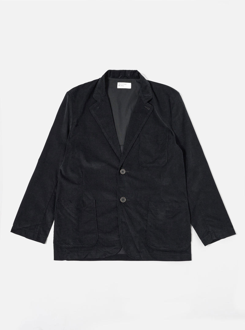 The Black Organic Fine Cord Two Button Jacket is shown as a flat lay against a white background. The jacket features a classic two-button front closure, a notch lapel, and two large patch pockets at the waist with a single chest patch pocket. The fine-wale organic cotton corduroy fabric provides a subtle vertical texture to the solid black garment.