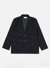 The Black Organic Fine Cord Two Button Jacket is shown as a flat lay against a white background. The jacket features a classic two-button front closure, a notch lapel, and two large patch pockets at the waist with a single chest patch pocket. The fine-wale organic cotton corduroy fabric provides a subtle vertical texture to the solid black garment.