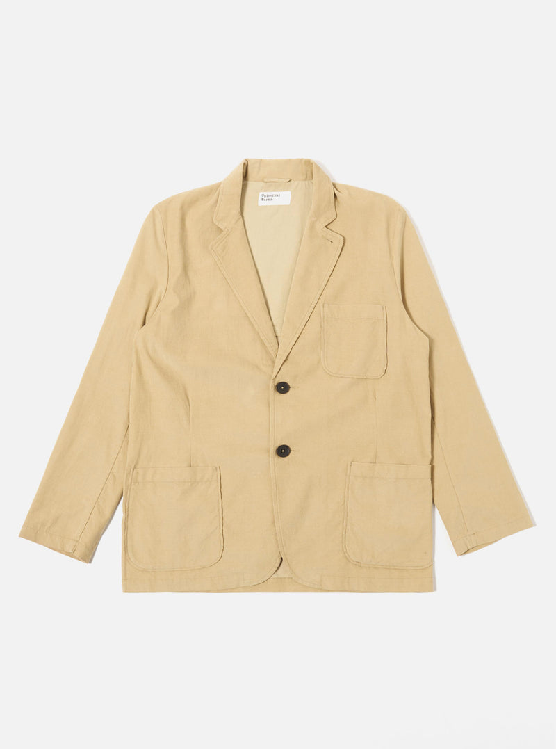 The Sand Organic Fine Cord Two Button Jacket is displayed as a flat lay against a plain white background. The jacket features a two-button front closure, a long and wide notched lapel, one chest patch pocket, and two larger patch pockets at the waist. The fine-wale organic cotton corduroy fabric has a visible vertical ribbed texture in a light sand color.