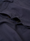 The Navy Peached Poplin Dutch Pant is shown as a flat lay against a white background. The trousers feature a wide-leg fit, an elasticated waistband with a drawstring, two large front patch pockets, and a single rear buttoned pocket. The peached cotton fabric has a soft, matte finish.