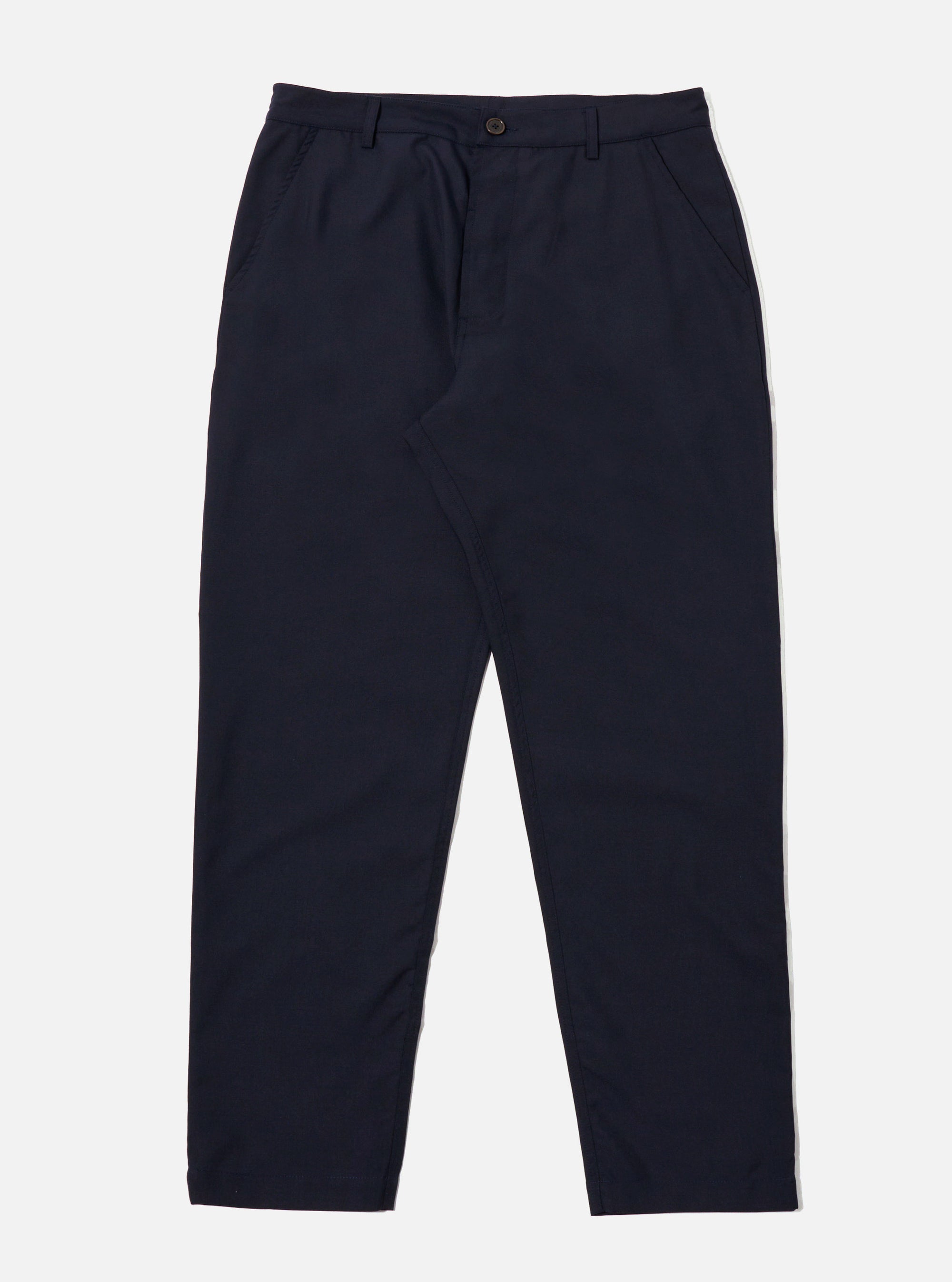 The Navy Tropical Suiting Military Chino is shown as a flat lay against a plain white background. The trousers feature a mid-rise, a button fly, and two front slanted pockets. The fabric is a smooth navy blue tropical suiting made from a wool and polyester blend.