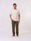 The Olive Recycled Polytech Military Chino is presented as a flat lay against a plain white background. The trousers feature a button fly, belt loops, and two slanted front pockets. The olive green fabric appears smooth with a technical finish.