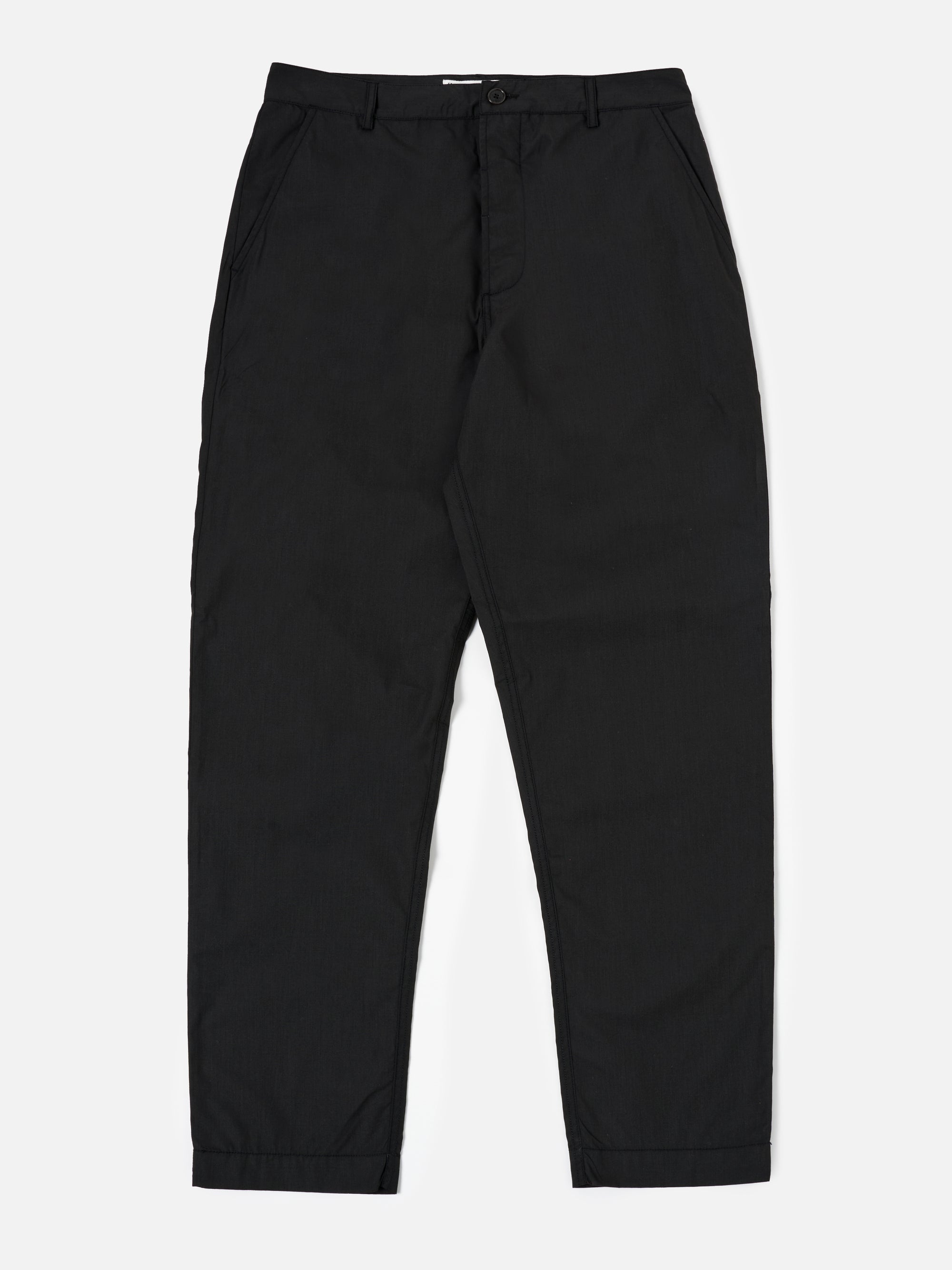 The Black Recycled Polytech Military Chino is shown as a flat lay against a plain white background. The trousers feature a button fly, belt loops, and a tapered leg design. Two front slash pockets and a small coin pocket are visible near the waistband. The black fabric has a smooth, technical finish.