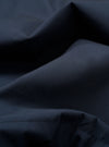A close-up swatch image of the Navy Recycled Polytech Military Chino fabric highlights the dark navy blue color and the smooth, densely woven technical texture of the recycled polyester and cotton blend.