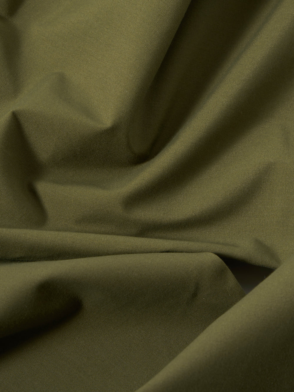 A close-up swatch image of the Olive Recycled Polytech Military Chino highlights the solid olive green color and smooth technical texture of the fabric.