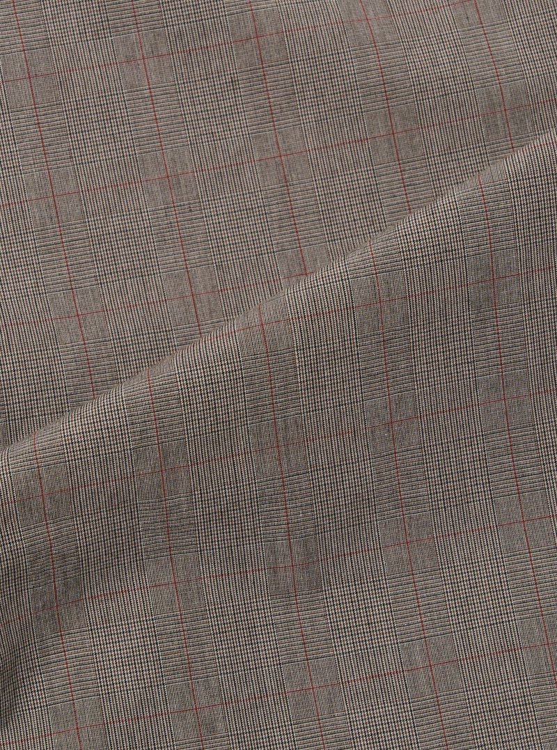 A close-up fabric swatch of the Grey Brown Wales Glen Check Pleated Track Pant is shown, highlighting the intricate weave of the brown and grey threads that form the classic glen check pattern. The textile fills the frame, showcasing the detailed texture of the cotton fabric.