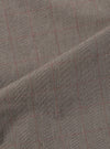 A close-up fabric swatch of the Grey Brown Wales Glen Check Pleated Track Pant is shown, highlighting the intricate weave of the brown and grey threads that form the classic glen check pattern. The textile fills the frame, showcasing the detailed texture of the cotton fabric.