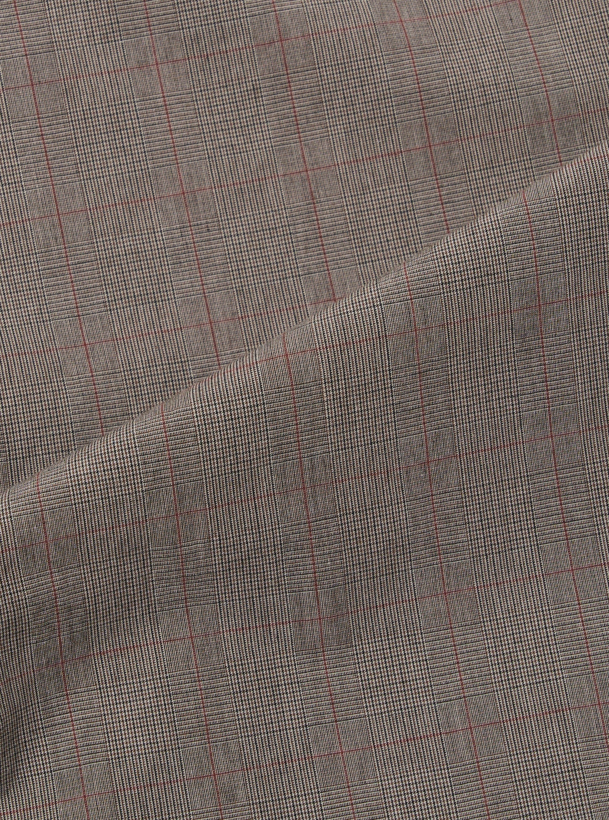 A close-up fabric swatch of the Grey Brown Wales Glen Check Pleated Track Pant is shown, highlighting the intricate weave of the brown and grey threads that form the classic glen check pattern. The textile fills the frame, showcasing the detailed texture of the cotton fabric.