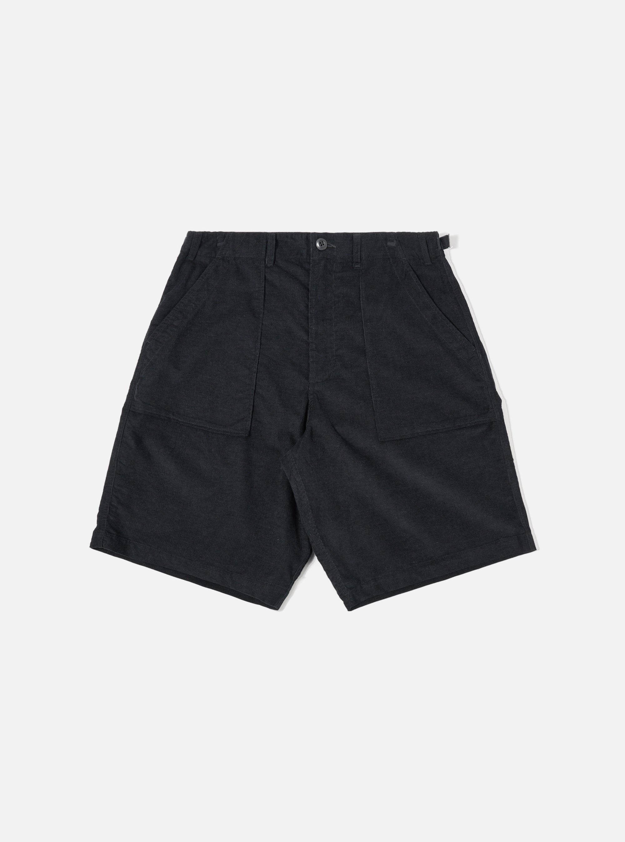The Black Organic Fine Cord Fatigue Short is shown as a flat lay against a plain white background. The shorts feature a button closure with a zip fly, large front patch pockets, and a distinct fine-ribbed corduroy texture.