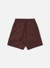 The Brown Peached Poplin Pleated Track Short is shown from the back as a flat lay against a plain white background. The image highlights the elasticated waistband, a single rear patch pocket on the right side, and the smooth texture of the brown cotton poplin fabric.