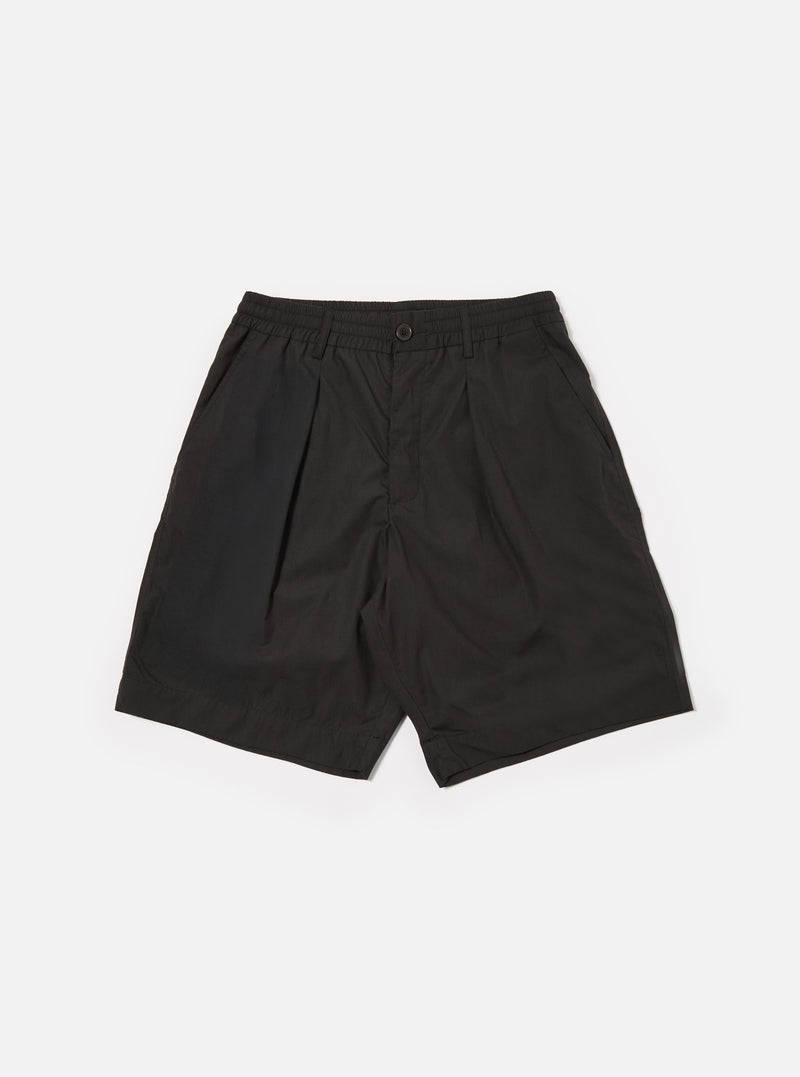 The Black Recycled Polytech Pleated Track Short is shown as a flat lay against a white background. The shorts feature an elasticated waistband with belt loops, a single pleat on each leg, and two side pockets. The fabric is a smooth, matte black recycled polytech material.