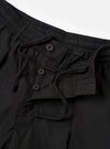 The Black Recycled Polytech Pleated Track Short is shown from the back as a flat lay against a plain white background. The shorts feature an elasticated waistband and a single rear patch pocket on the right side. The black fabric has a smooth, technical appearance with visible tonal stitching.
