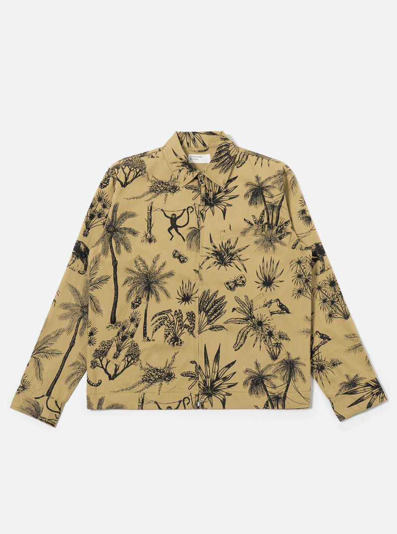 The Sand Jungle Toile Twill Windcheater Jacket is shown as a flat lay against a plain white background. The jacket features an all-over jungle toile print with dark illustrations of foliage and animals on a sand-colored base. It has a classic pointed collar, a central zip front, two slanted side pockets, and elasticated cuffs and hem.
