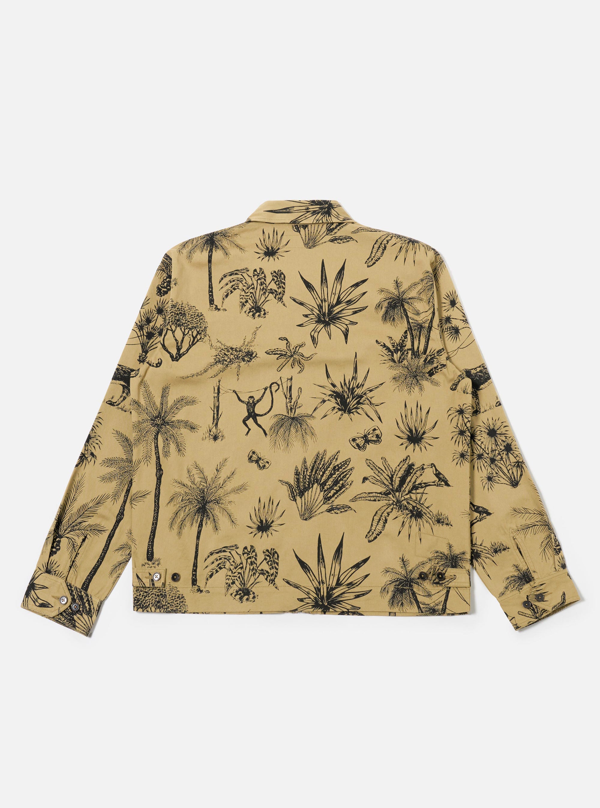 The Sand Jungle Toile Twill Windcheater Jacket is shown from the back as a flat lay against a plain white background. The jacket features an all-over intricate jungle toile print with dark botanical and animal illustrations on a sand-colored base. The garment is constructed with a simple back panel, a straight hem, and a standard collar.