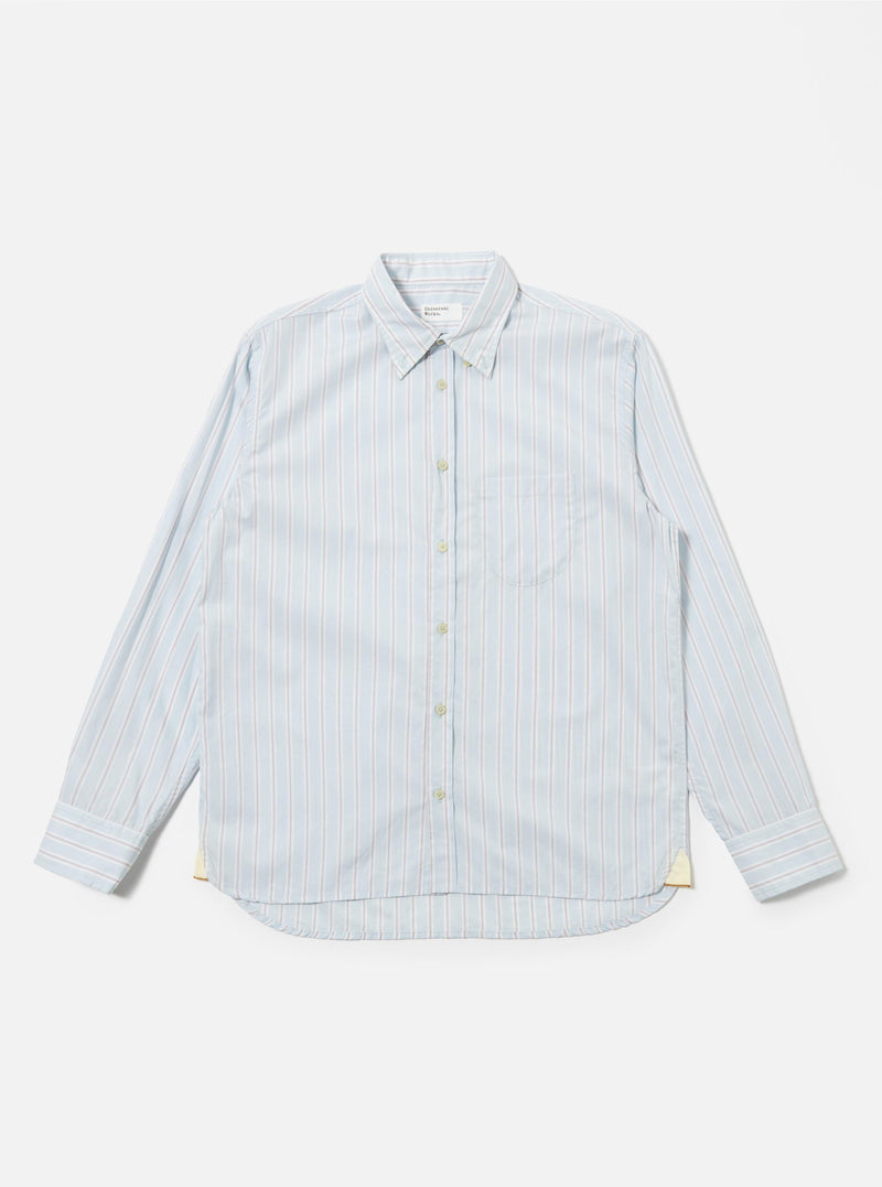 The Sky Urban Stripe Lazy Day Shirt is shown as a flat lay against a white background. The shirt features a light blue and white vertical stripe pattern, a button-down collar, a single chest pocket on the left side, and a full button-up front.