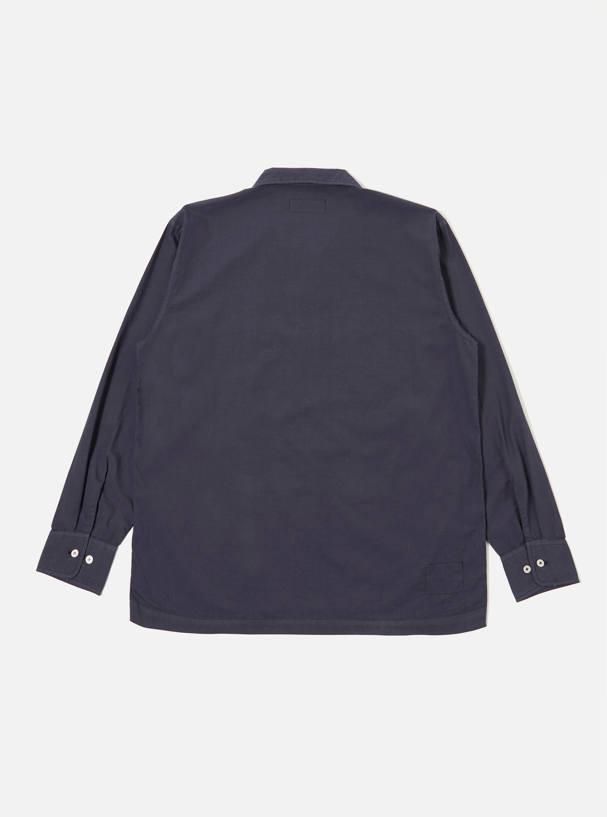 The Navy Poplin Dwight Overshirt is presented from the back as a flat lay against a plain white background. The image highlights the straight hem, the rear of the Cuban collar, and the smooth texture of the navy blue cotton poplin fabric.