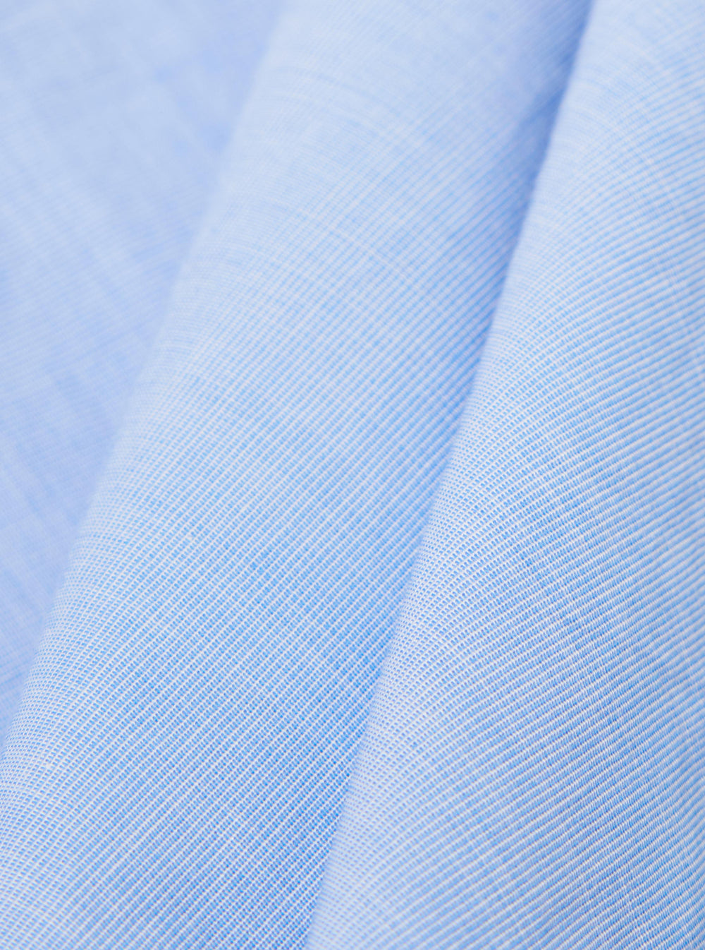 A close-up fabric swatch of the Sky/Blue Fil A Fil Mixed Square Pocket Shirt displays a light blue and white woven texture. The image focuses on the fine, grid-like pattern of the cotton fabric.